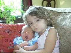 The big sister with a sleepy baby!