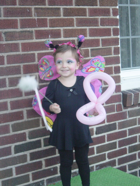 Ms. Butterfly striking a pose. The balloon is a butterfly that Lolly the Clown made for her yesterday. We met Lolly at the new mall.