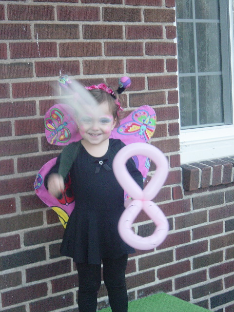 Casting a spell with her magic wand.